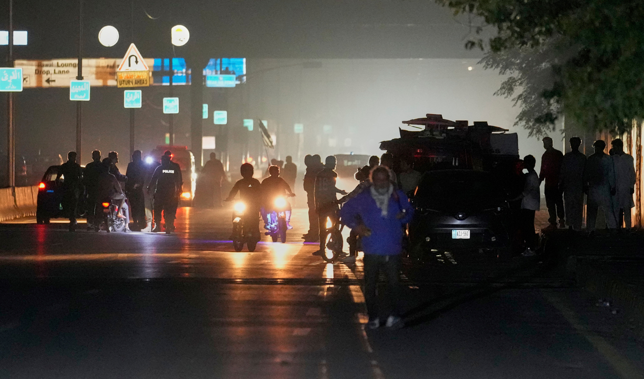 Pakistani police officers remove vehicles and people from the main entry of Nur Khan air base following an Indian missile strike in Rawalpindi, Pakistan on May 10, 2025. (AP)