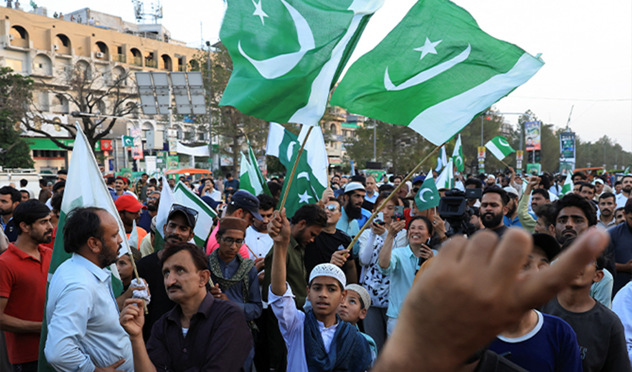 People wave Pakistani flags in celebration after the ceasefire announcement between India and Pakistan, in Islamabad, Pakistan, May 10, 2025. (Reuters)
