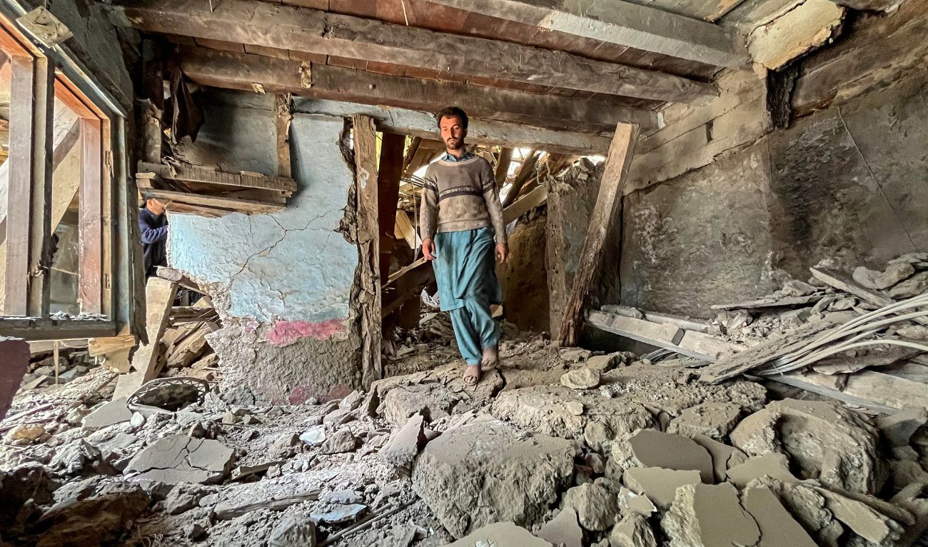 A resident walks over the debris of his damaged house after cross-border shelling along the Line of Control (LoC) between Pakistan and India, in the Jura sector in Neelum Valley of Pakistan-administered Kashmir, on May 10, 2025. (AFP)