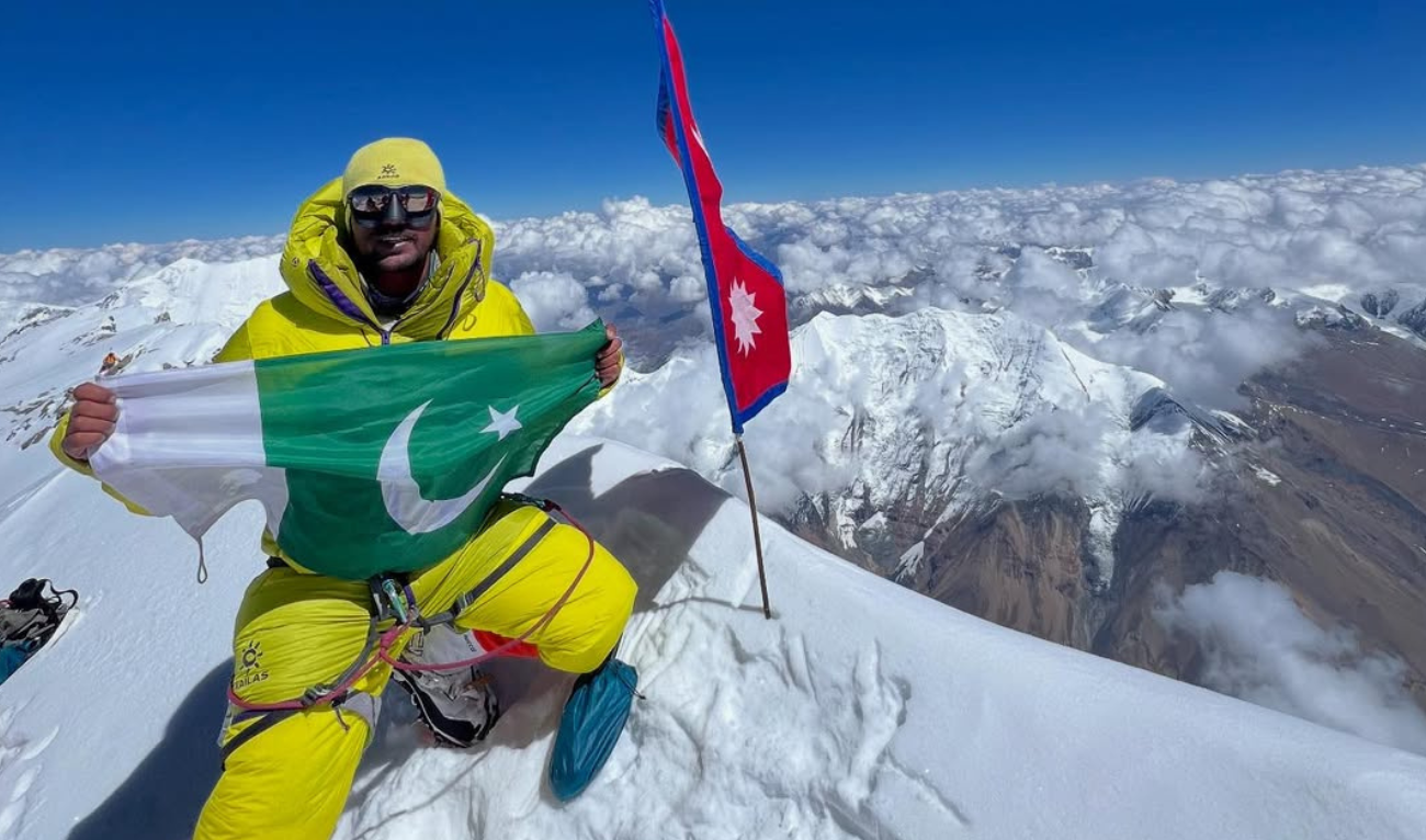 In this photo shared on May 11, 2025, Pakistani climber Sajid Ali Sadpara poses with Pakistani flag on the top of Nepal's Dhaulagiri mountain. (Photo courtesy: Sajid Ali Sadpara/ Instagram)