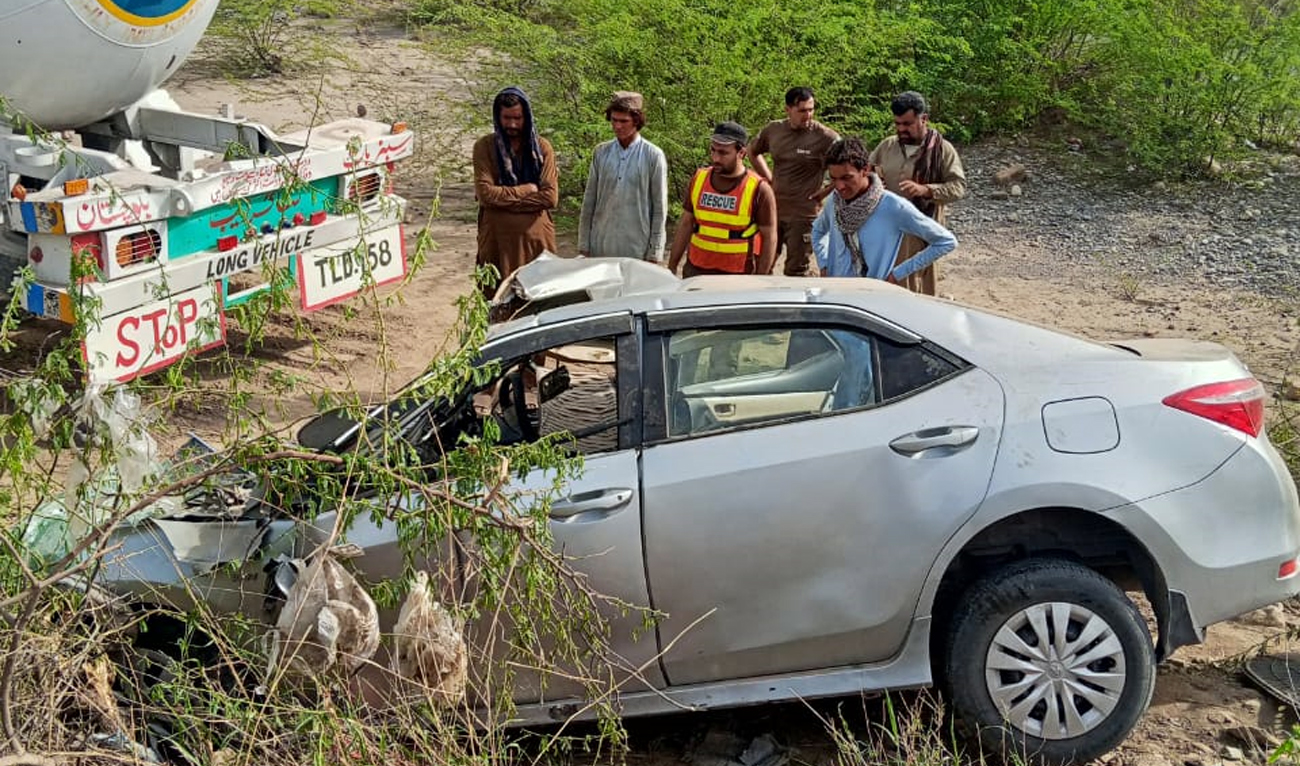 Rescue 1122 officials look at the car that collided with a gas tanker in the Daraban area of Khyber Pakhtunkhwa’s Dera Ismail Khan district, Pakistan, on May 12, 2025. (Rescue 1122)