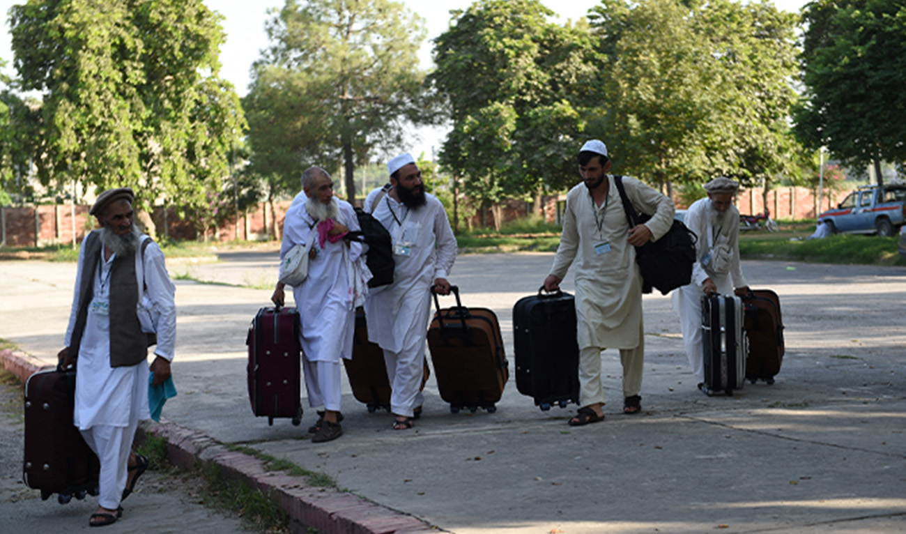 Pakistani Hajj pilgrims walk towards waiting transport at The Hajj Complex in Islamabad on August 23, 2016, before leaving for the annual Hajj pilgrimage to the Islamic holy cities of Mecca and Medina in Saudi Arabia. (AFP/File)