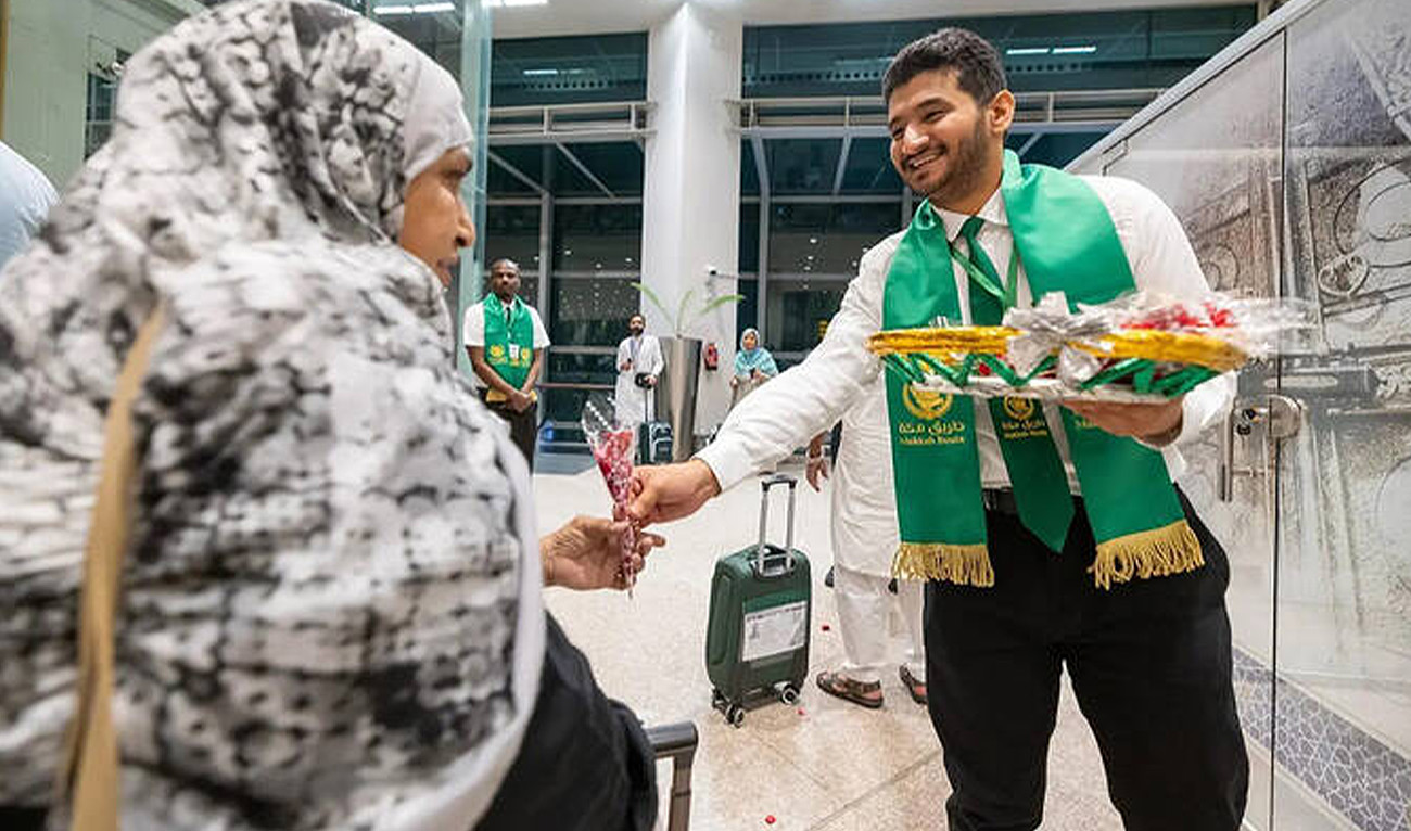 Saudi official gives flower to a Pakistani pilgrim departing from Islamabad International Airport in Islamabad, Pakistan, on April 29, 2025 for this year's Hajj. (Saudi Press Agency)
