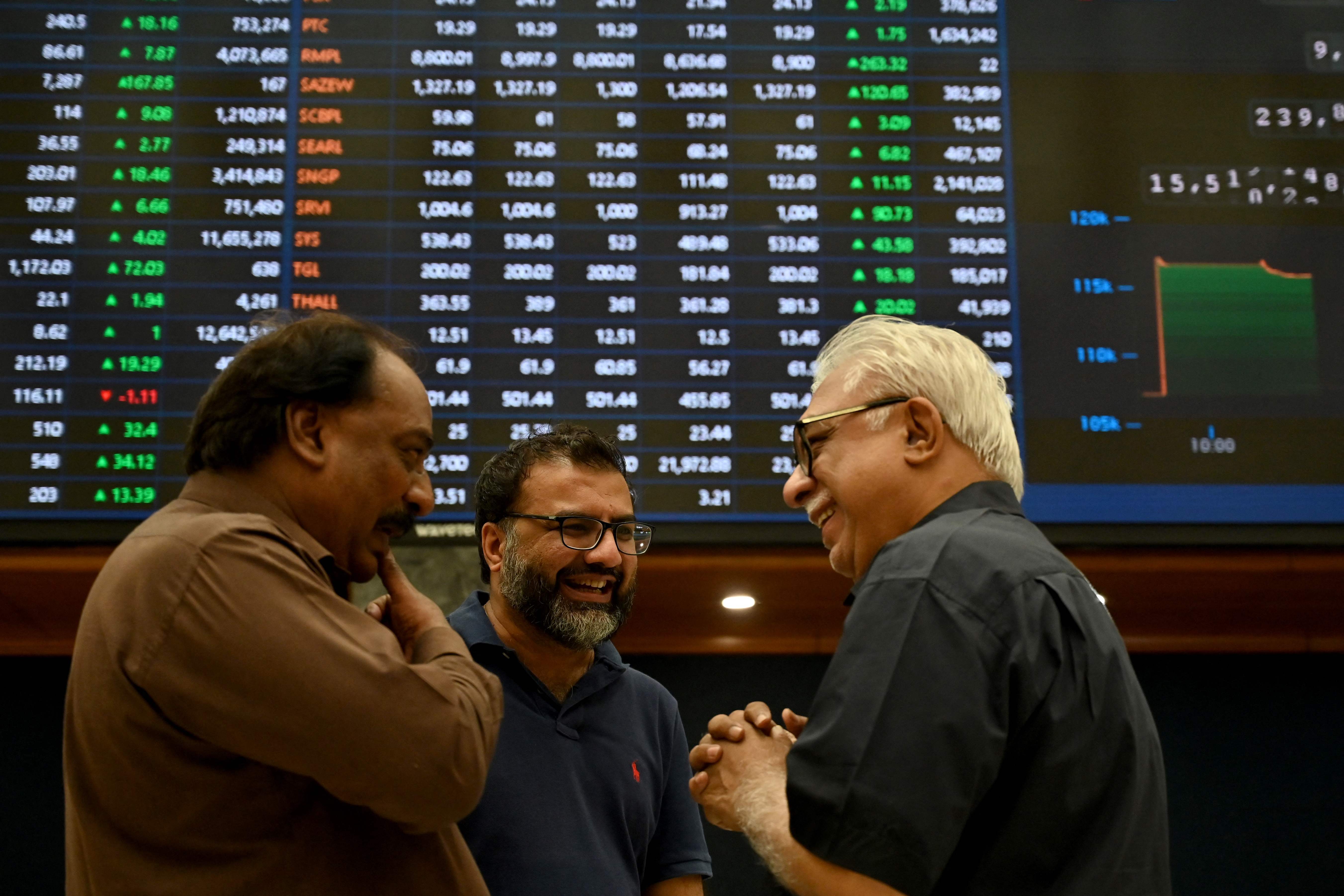 Stockbrokers interact during a trading session at the Pakistan Stock Exchange (PSX) in Karachi on May 12, 2025. (AFP)