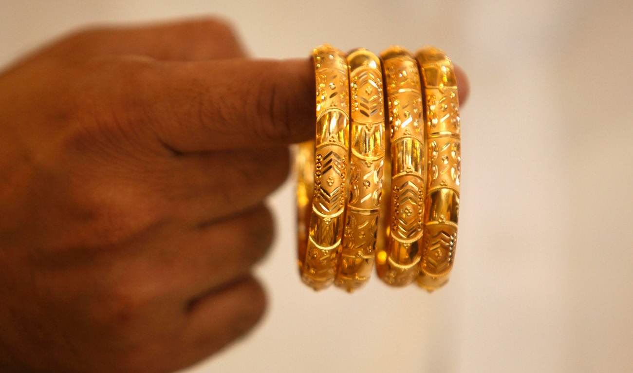 A man displays gold bangles at a jewelry shop in Karachi, Pakistan, on November 24, 2009. (Reuters/File)