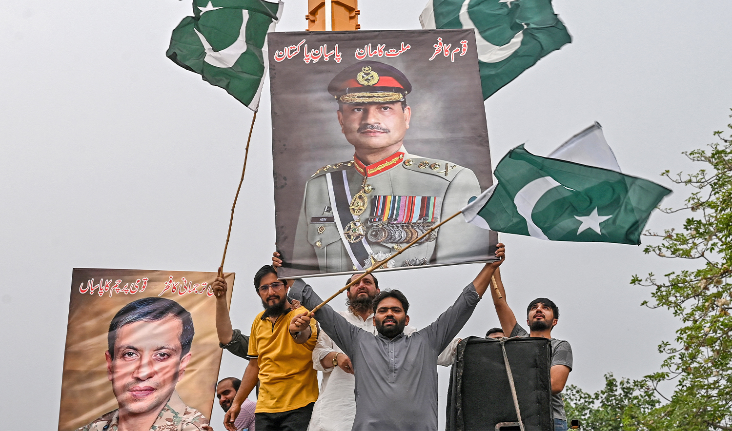 Demonstrators carrying posters with portraits of Pakistan's Chief of Army Staff General Syed Asim Munir shout slogans as they participate in an anti-India protest in Lahore on May 11, 2025. (AFP)