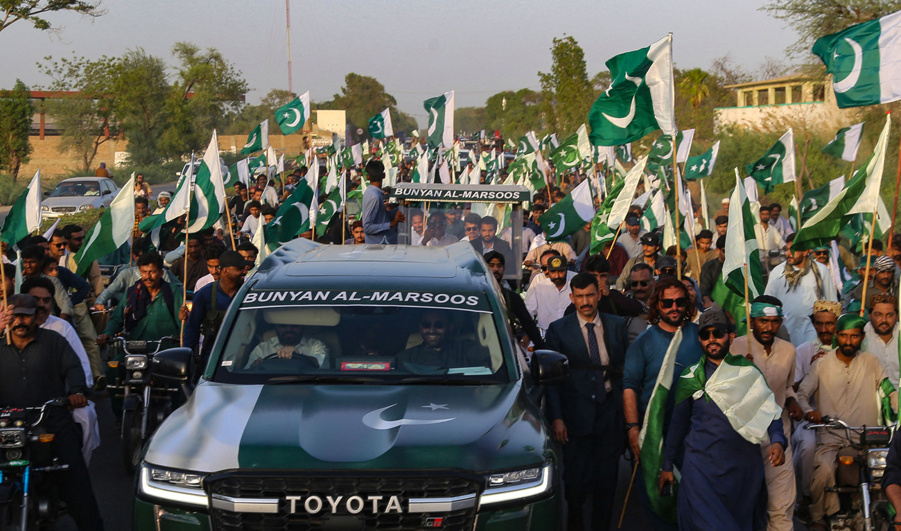 People hold Pakistan’s national flags during a rally to express their solidarity with Pakistan’s armed forces, in Hyderabad, Sindh province, on May 14, 2025. (AFP)