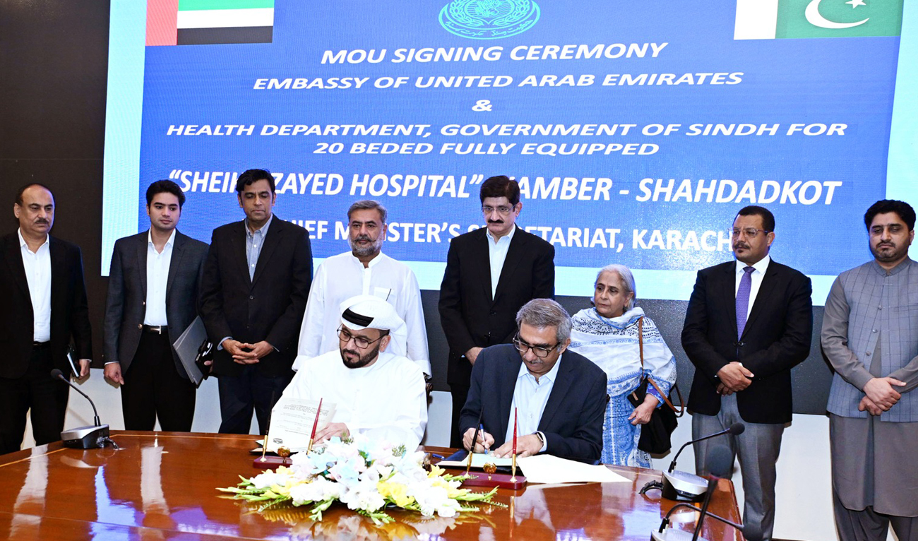 UAE Consul General Bakheet Ateeq Al-Rumaithi (left) and Sindh Health Secretary Rehan Baloch (right) sign the MoU for the establishment of a 20-bed hospital in Kambar area of Sindh province, as Sindh Chief Minister Syed Murad Ali Shah (4R), along with Health Minister Dr. Azra Faazl Pechuho (3R) and other officials, witnesses the signing ceremony in Karachi on May 15, 2025. (Photo courtesy: Handout/Sindh government)