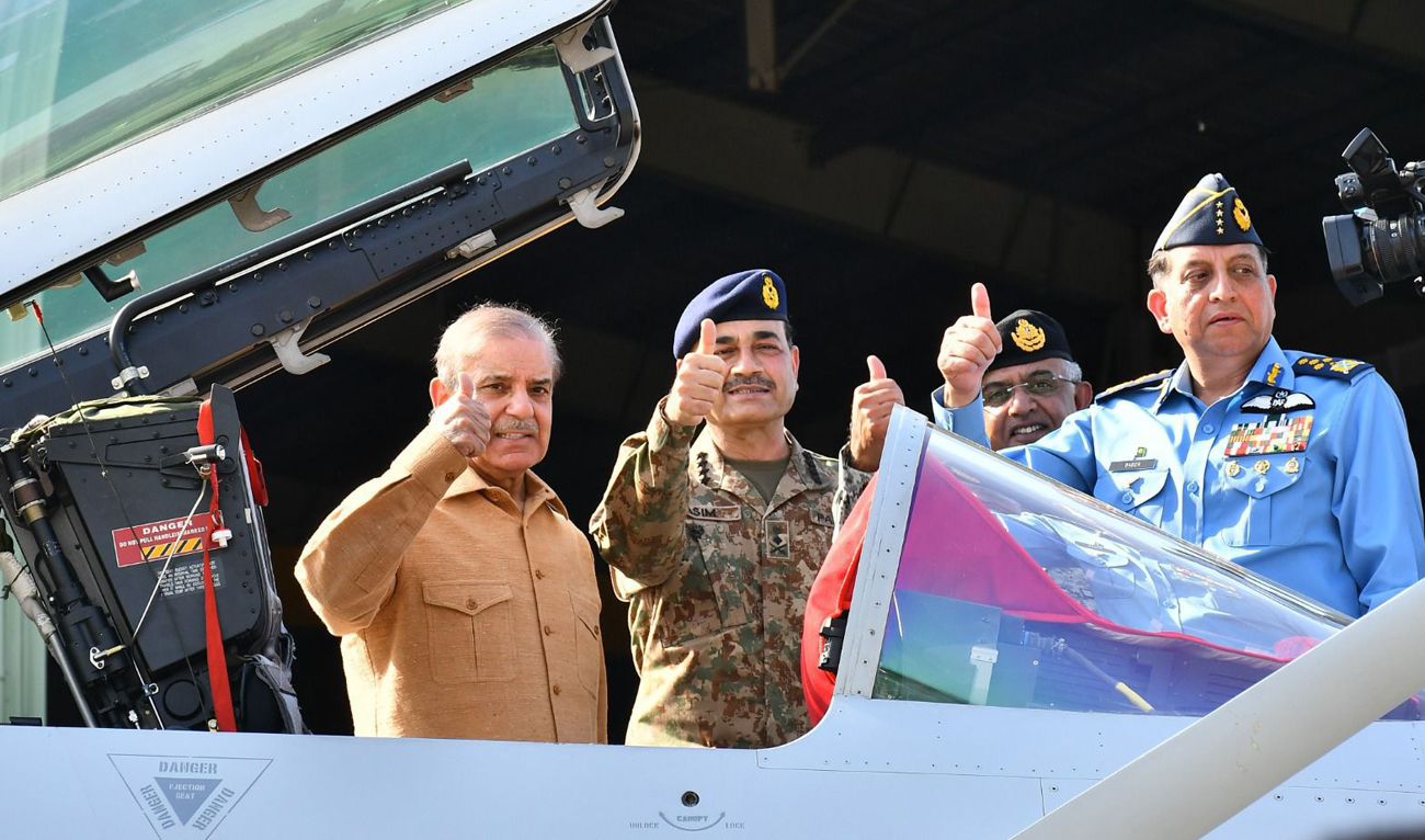 (From left to right) This handout photo, taken and released by Pakistan’s Inter-Services Public Relations (ISPR), shows Pakistan Prime Minister Shehbaz Sharif with Army Chief General Syed Asim Munir, Chief on the Naval Staff Admiral Naveed Ashraf and Air Chief Marshal Zaheer Ahmed Baber Sidhu during a visit to Kamra Airbase in Attock, Pakistan on May 15, 2025. (Photo courtesy: Handout/ISPR)