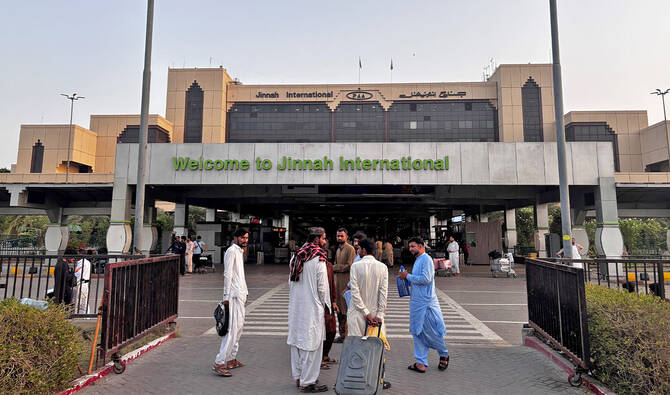 Passengers wait outside at Jinnah International airport after all domestic and international flights were canceled in Karachi on May 7, 2025. (AFP/File)