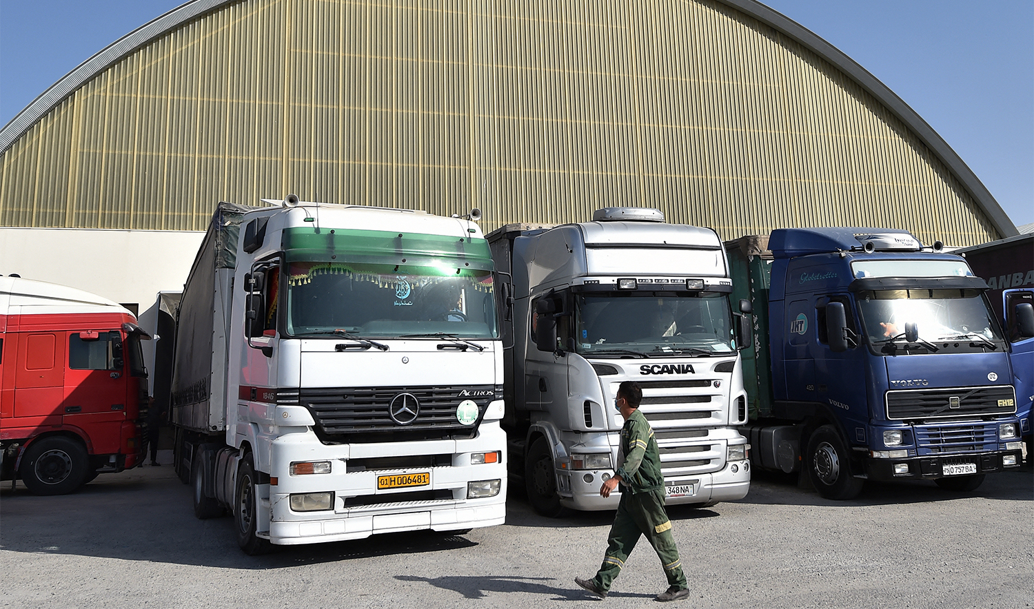 A driver walks near trucks in Termez Cargo Centre near the city of Termez, some 800 kms from Uzbekistan capital Tashkent, on October 18, 2021. (AFP/File)