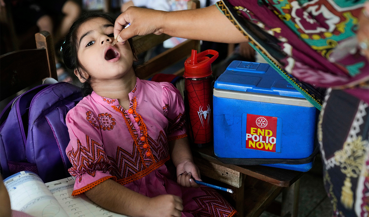 A health worker administers a polio vaccine to a child in a school in Lahore, Pakistan, on April 21, 2025. (AP/File)
