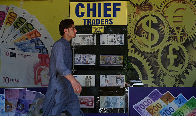 A man walks past a foreign currency exchange market in Islamabad on July 11, 2023. (AFP/File)