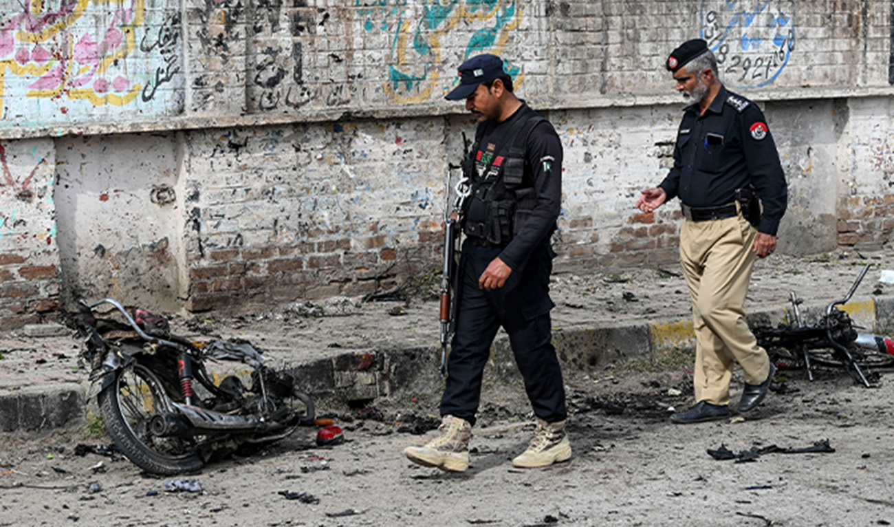 Security personnel examine the site of a blast in Pakistan's northwest Peshawar district of the Khyber Pakhtunkhwa province on March 10, 2024. (AFP/File)