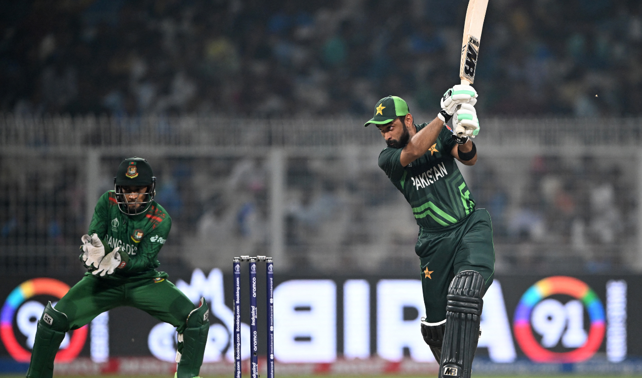 Pakistan's Abdullah Shafique (R) plays a shot as Bangladesh's wicketkeeper Mushfiqur Rahim watches during the 2023 ICC Men's Cricket World Cup one-day international (ODI) match between Pakistan and Bangladesh at the Eden Gardens in Kolkata on October 31, 2023. (AFP)