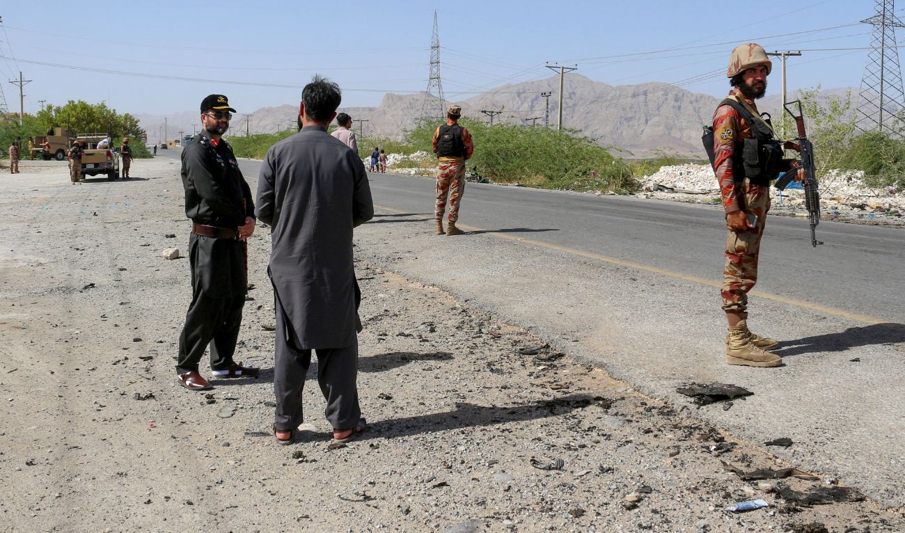 Security personnel stand guard at the site of a school bus bombing in Khuzdar district of Balochistan province on May 21, 2025. (AFP)