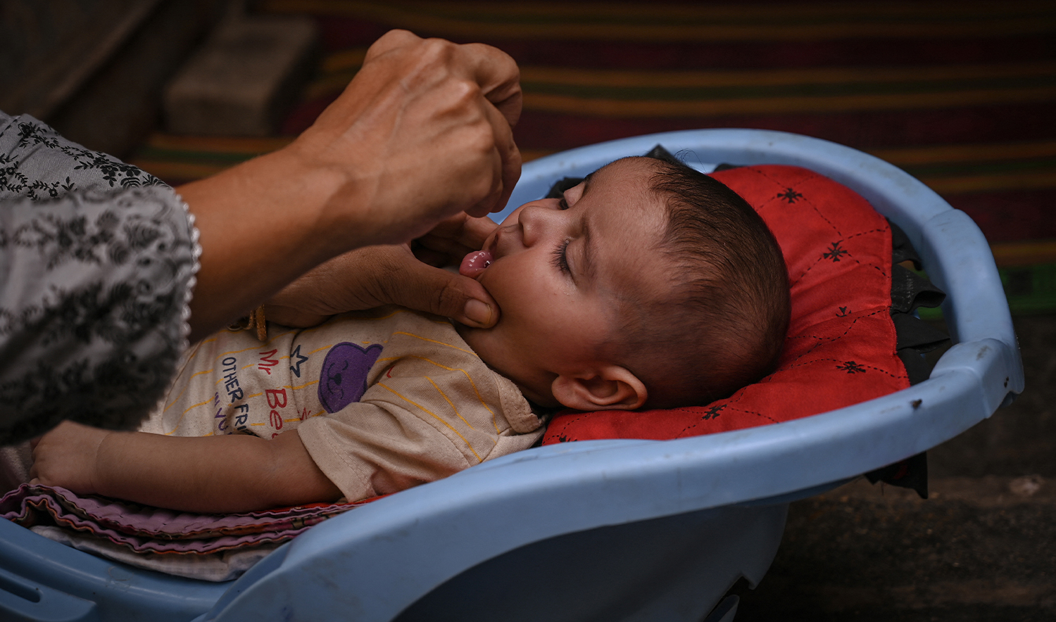 A health worker administers polio drops to a child during a door-to-door vaccination campaign in Karachi on October 28, 2024. (AFP/File)