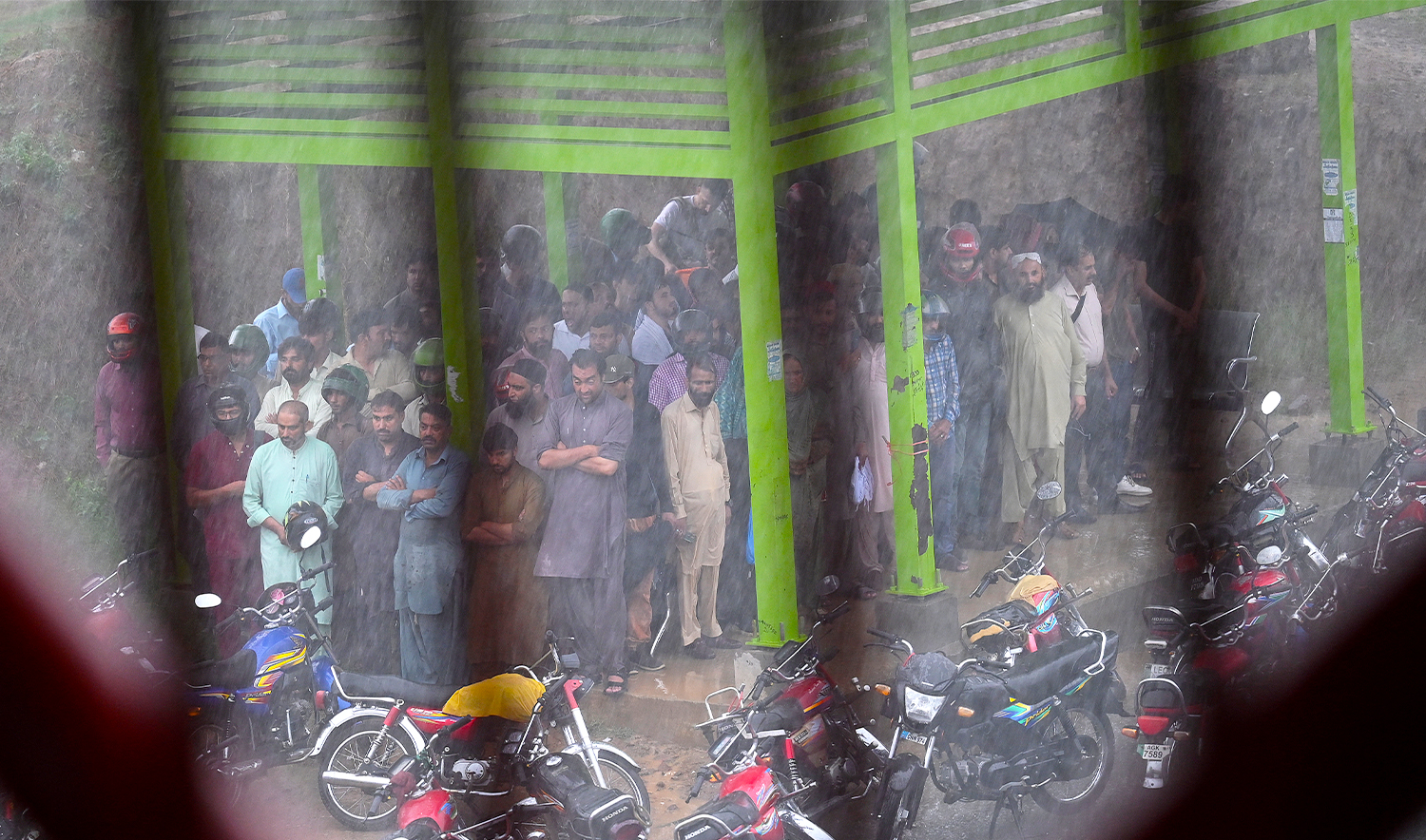 People take shelter amid heavy monsoon rains in Islamabad on July 10, 2024. (AFP/File)