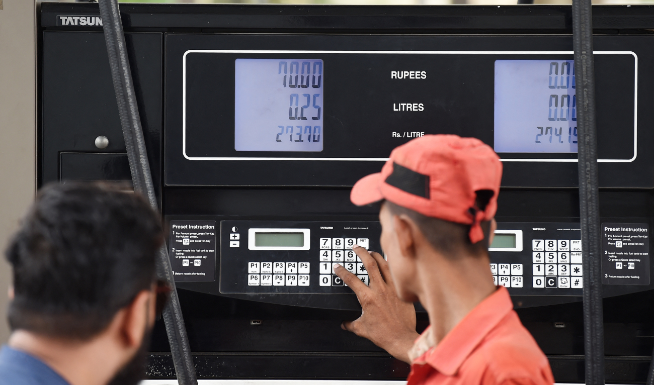 An employee prepares to fill petrol in a vehicle at a fuel station in Karachi on August 1, 2023. (AFP/ file)