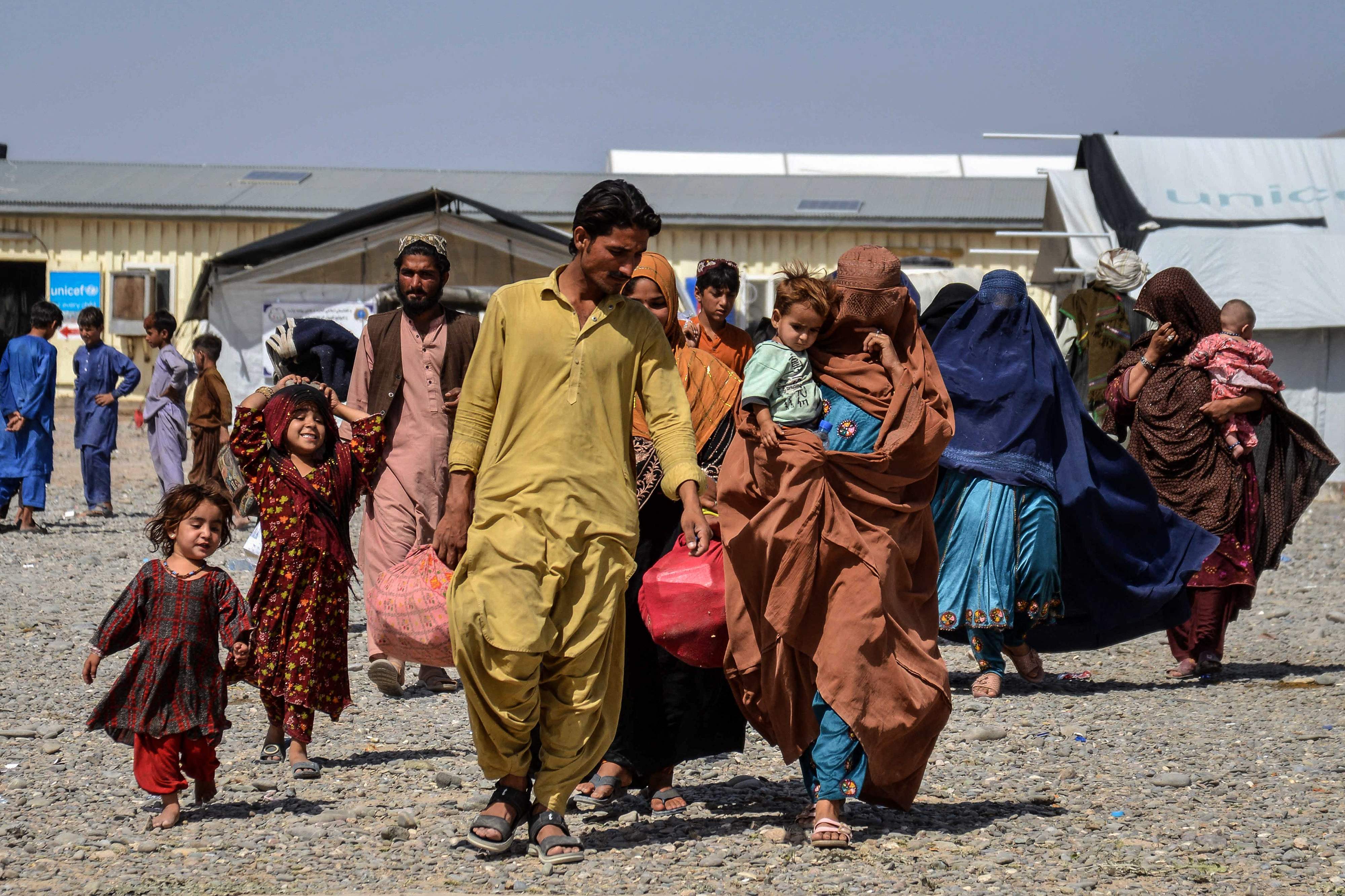 Afghan refugees carrying their belongings arrive from Pakistan at a registration center in Takhta Pul district of Kandahar province on April 13, 2025. (AFP/File)