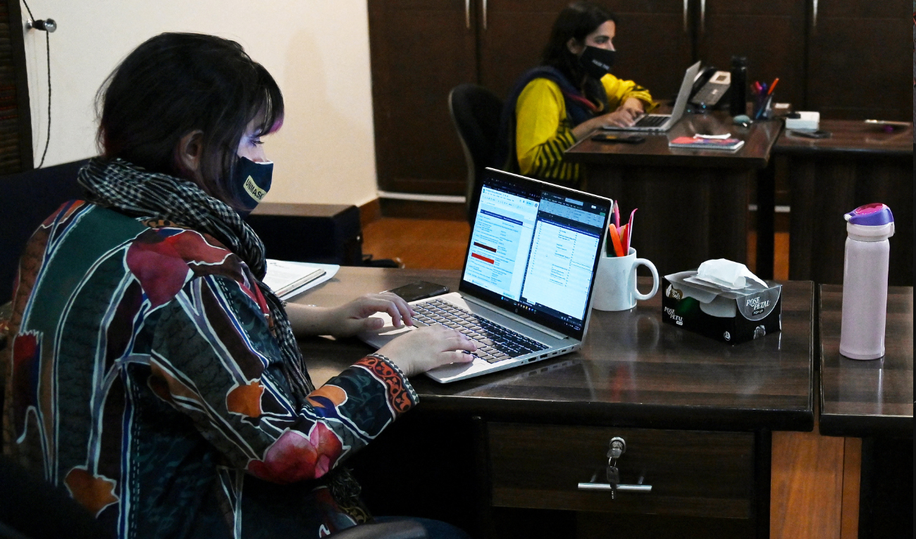 In this photograph taken on October 21, 2024, staff members work at the Digital Rights Foundation (DRF), an NGO aims to strengthen protections for human rights defenders in digital spaces, in Lahore. (AFP)