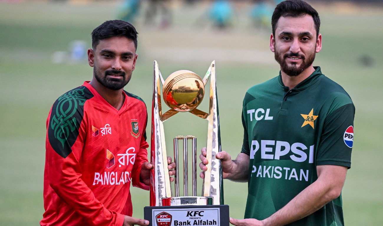 Pakistan's captain Salman Agha (R) and his Bangladesh counterpart Litton Das pose with the trophy at the Gaddafi Cricket Stadium in Lahore on May 27, 2025, ahead of their first T20 International cricket match of the three match series. (AFP)