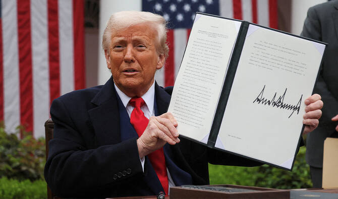 US President Donald Trump holds a signed executive order on tariffs, in the Rose Garden at the White House in Washington, DC, US, April 2, 2025. (REUTERS/File)