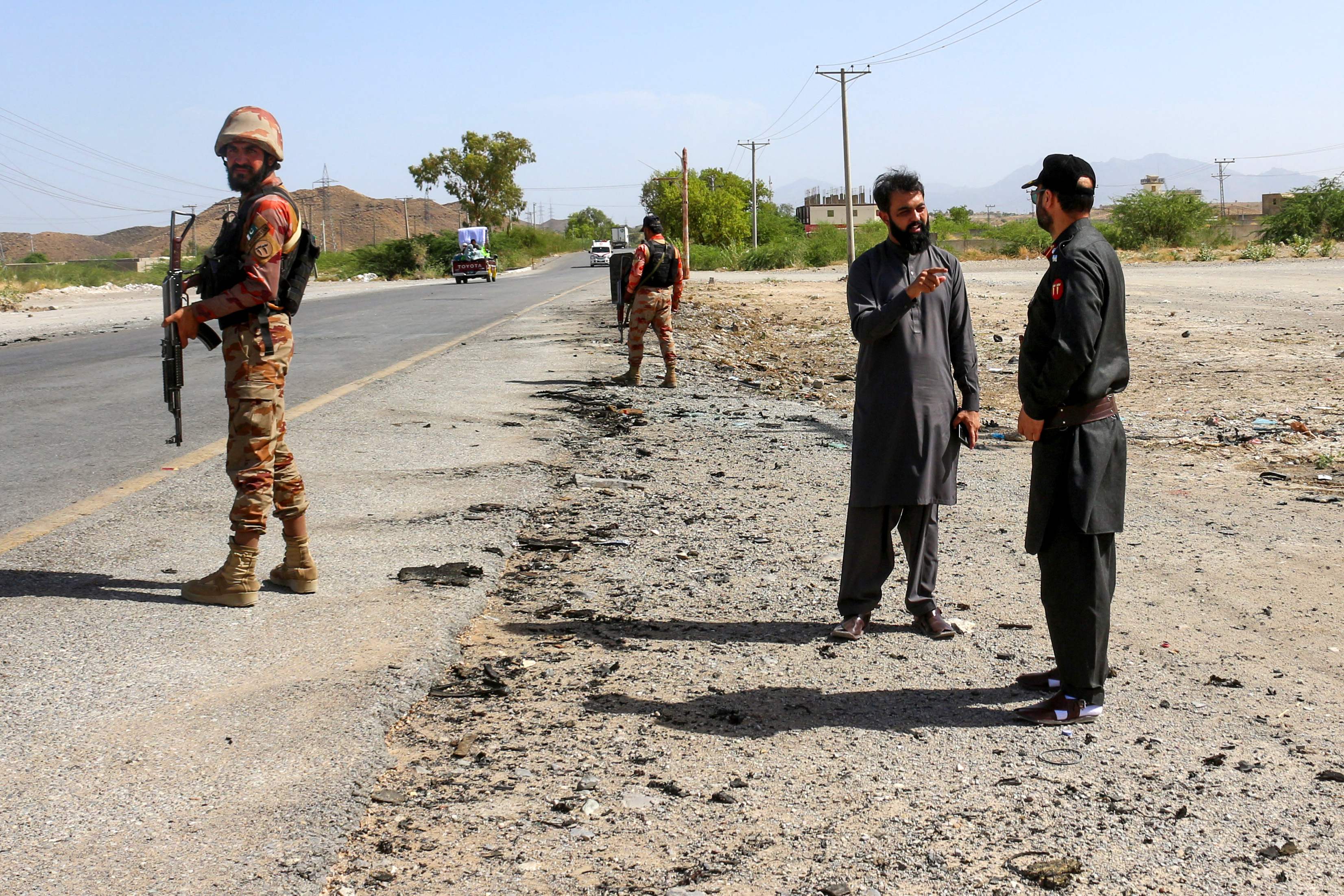 Security personnel stand guard at the site of a school bus bombing in Khuzdar district of Balochistan province on May 21, 2025. (AFP/File)