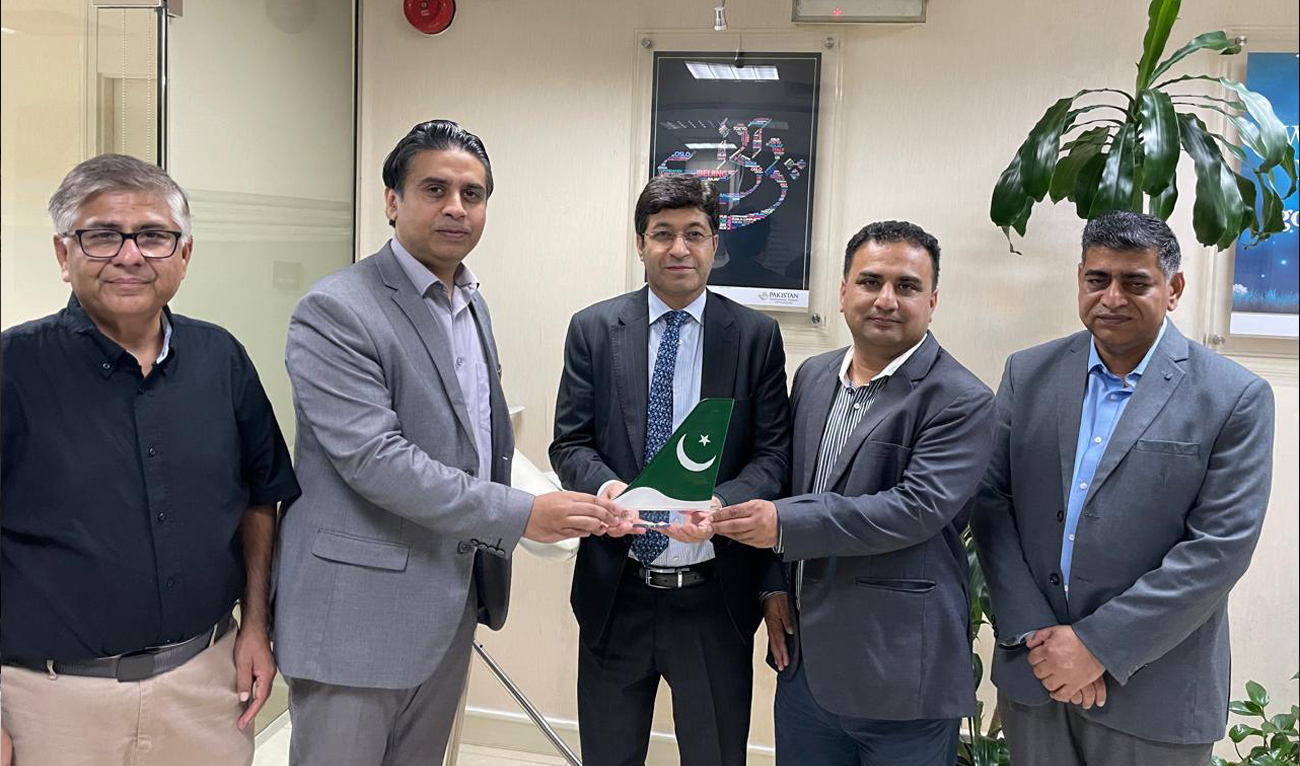This handout photo, released by Consulate General of Pakistan on May 30, 2025, shows officials posing for a group photograph during the re-launch of Dubai-Skardu flights, at the PIA office in Dubai. (Photo courtesy: Handout/Pakistan embassy)