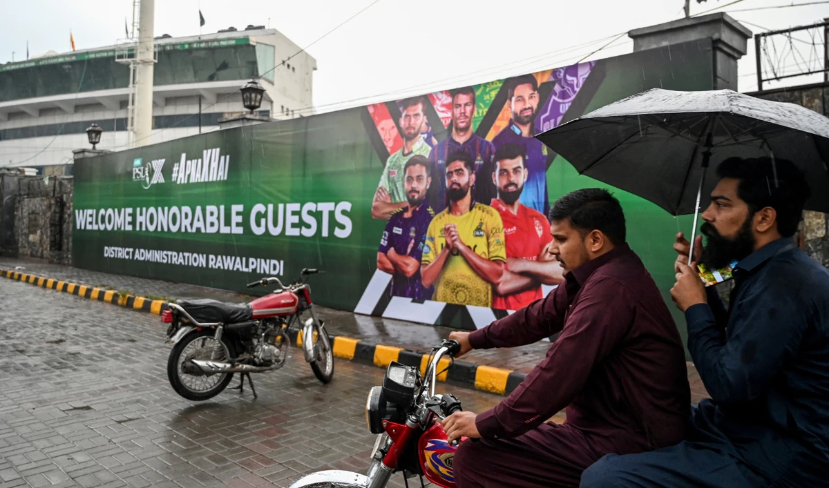 Men ride on a motorbike in front of the Rawalpindi cricket stadium after an alleged drone was shot down in Rawalpindi on May 8, 2025. (AFP)