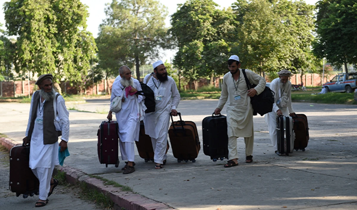 Pakistani Hajj pilgrims walk towards waiting transport at The Hajj Complex in Islamabad on August 23, 2016, before leaving for the annual Hajj pilgrimage to the Islamic holy cities of Mecca and Medina in Saudi Arabia. (AFP/File)