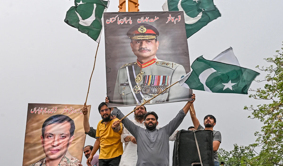 Demonstrators carrying posters with portraits of Pakistan's Chief of Army Staff General Syed Asim Munir shout slogans as they participate in an anti-India protest in Lahore on May 11, 2025. (AFP)