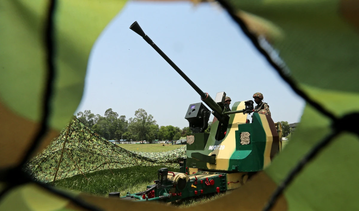 Indian army soldiers stand next to an anti-aircraft gun at Akhnoor sector near the Line of Control (LoC) between India and Pakistan, in Jammu region on May 19, 2025. (AFP)