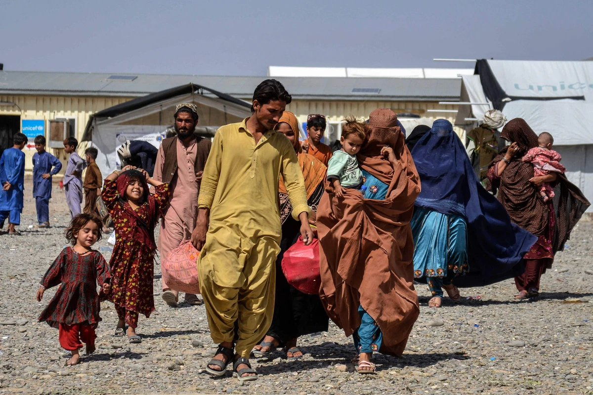 Afghan refugees carrying their belongings arrive from Pakistan at a registration center in Takhta Pul district of Kandahar province on April 13, 2025. (AFP/File)
