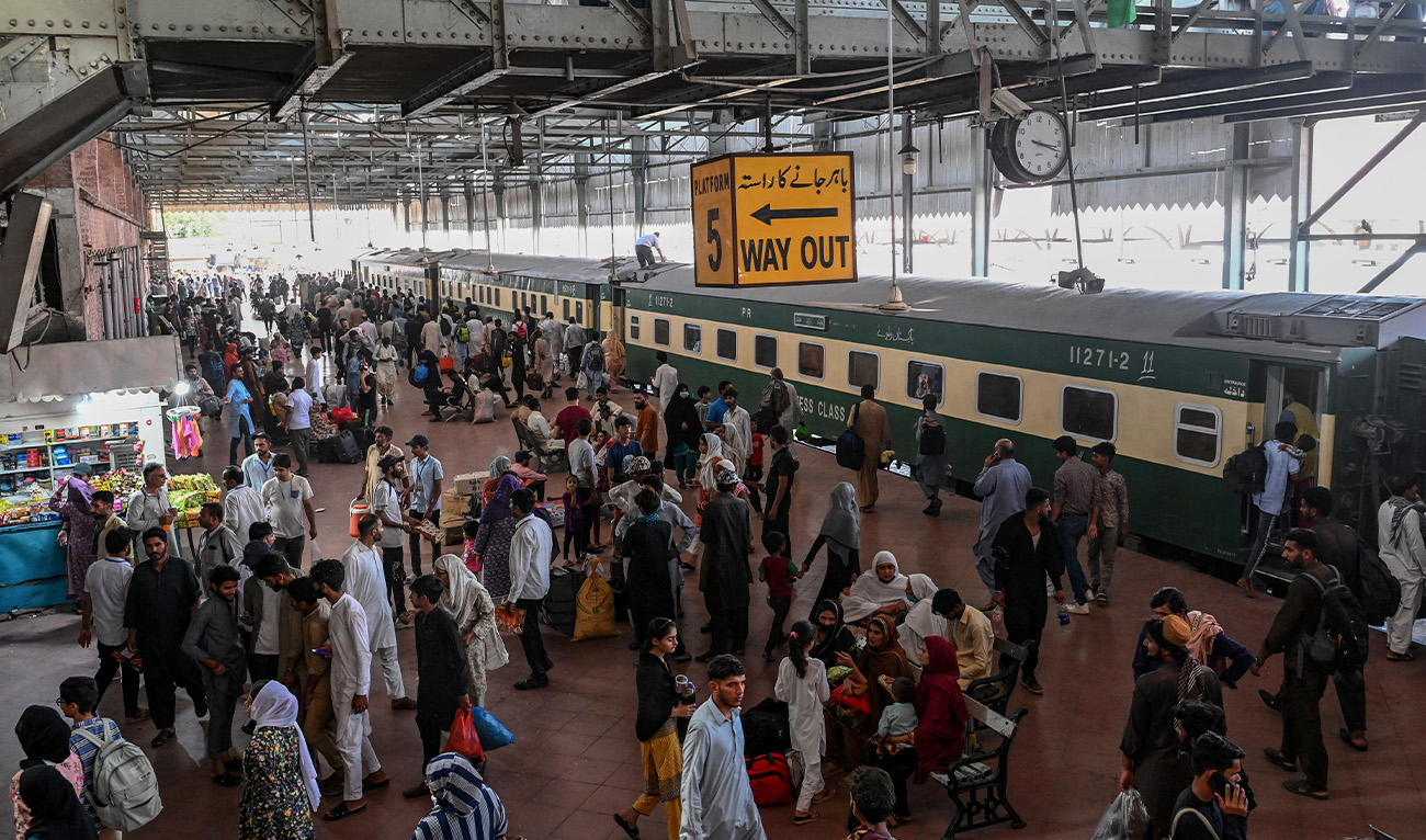 People wait to board a train at a railway station in Lahore on June 15, 2024, as they travel back home ahead of Eid al-Adha, the feast of the sacrifice marking the end of the Hajj pilgrimage to Mecca. (AFP/File)