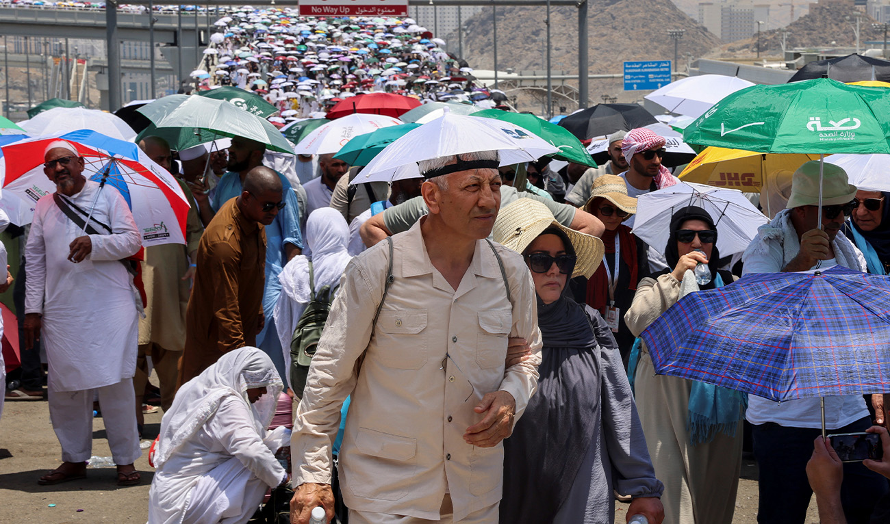 Muslim pilgrims walk with umbrellas on the third day of the Satan stoning ritual, amid extremely hot weather, during the annual haj pilgrimage, in Mina, Saudi Arabia, June 18, 2024. (Reuters/File)