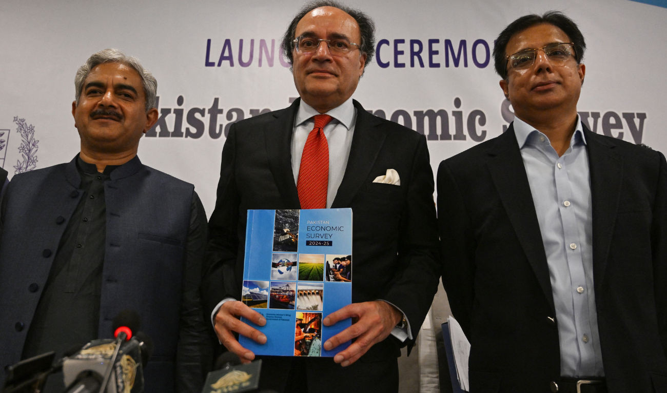 Pakistan's Finance Minister Muhammad Aurangzeb holds copy of Pakistan Economic Survey 2024-25 as Finance Secretary Imdadullah Bosal (R) and Imtiaz Ahmed (L), Chief Economist, Ministry of Planning, Development and Special Initiatives after a media briefing in Islamabad June 9, 2025, ahead of the state budget. (AFP)