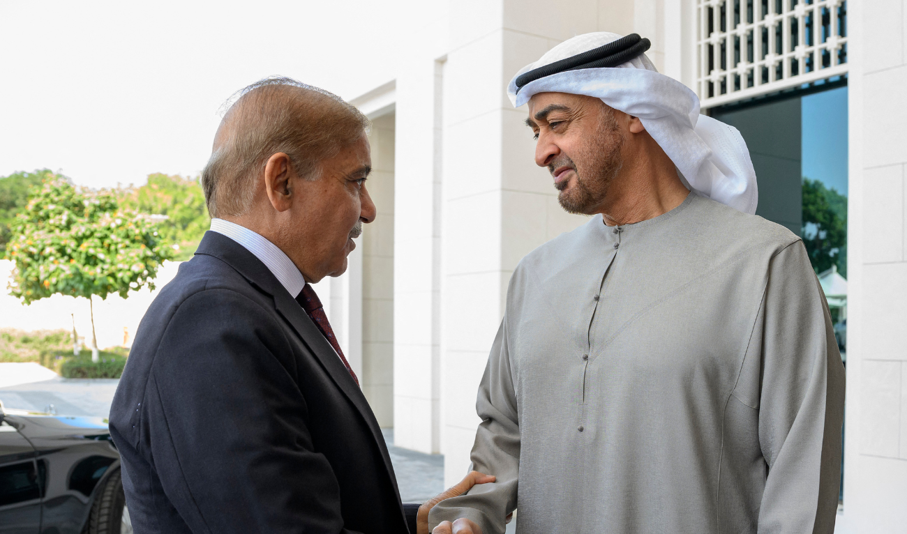This handout image provided by the UAE Presidential court on January 12, 2023 shows UAE President Sheikh Mohamed bin Zayed al-Nahyan welcoming Shehbaz Sharif, Prime Minister of Pakistan (L), prior to their meeting, at Al Shati Palace in Abu Dhabi. (Photo by Hamad AL-KAABI / UAE PRESIDENTIAL COURT / AFP)