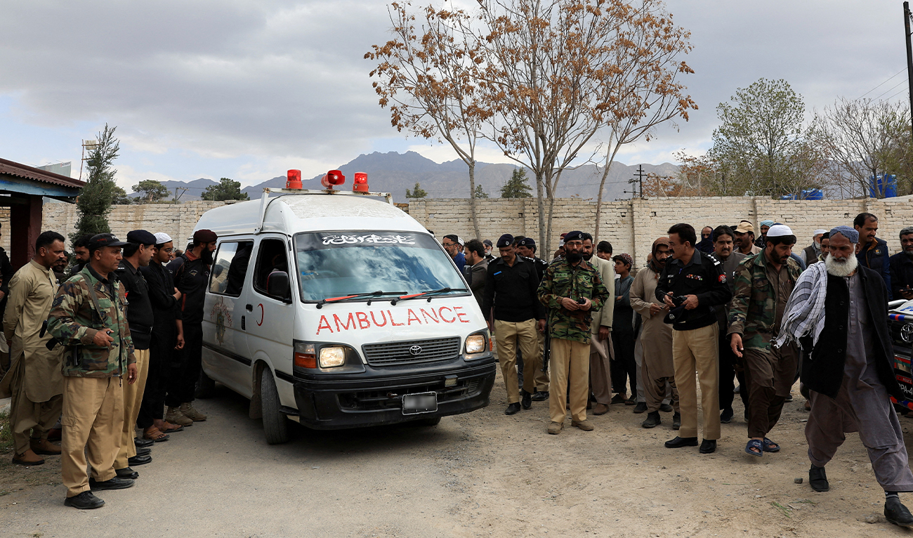 People gather next to an ambulance carrying the bodies of people, who were killed after a train was attacked by separatist militants in Bolan, during the funeral in Quetta, Pakistan, on March 13, 2025. (REUTERS/File)