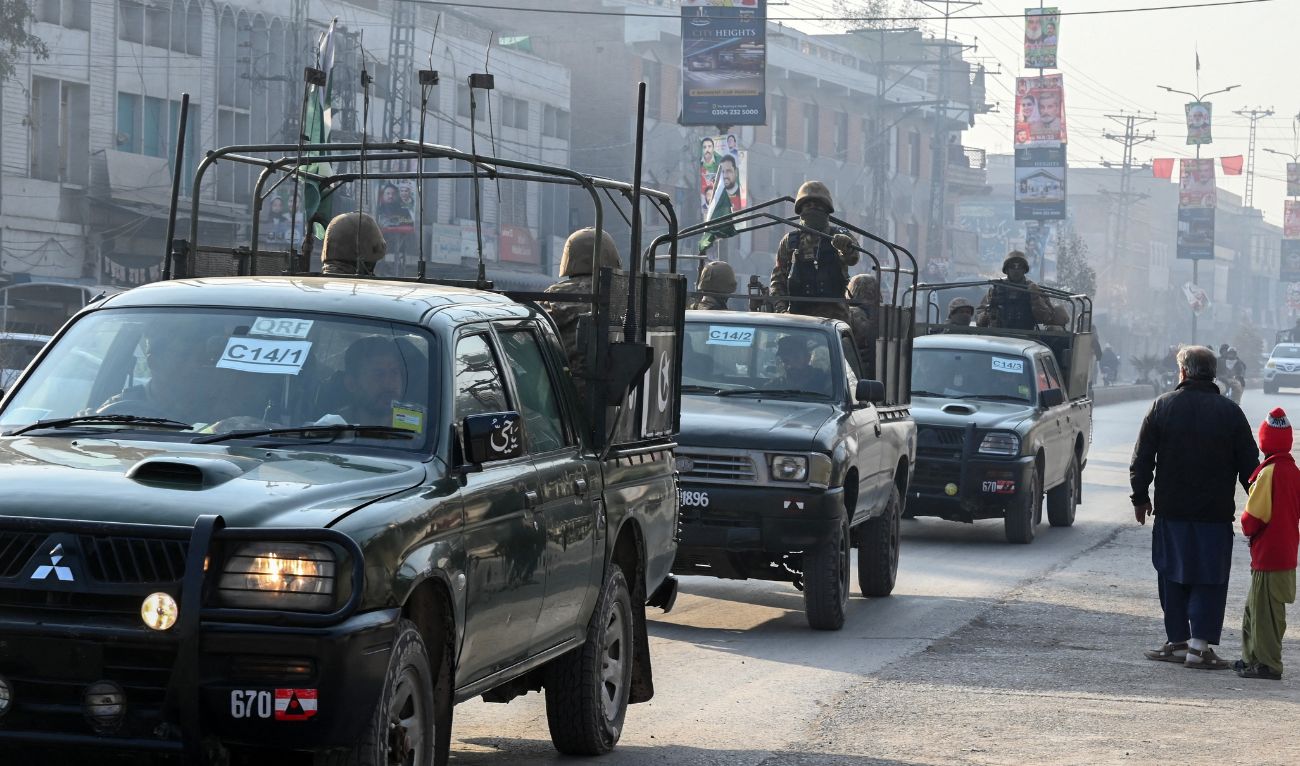 A Pakistan Army convoy patrols along a road in Peshawar on February 7, 2024. (AFP)