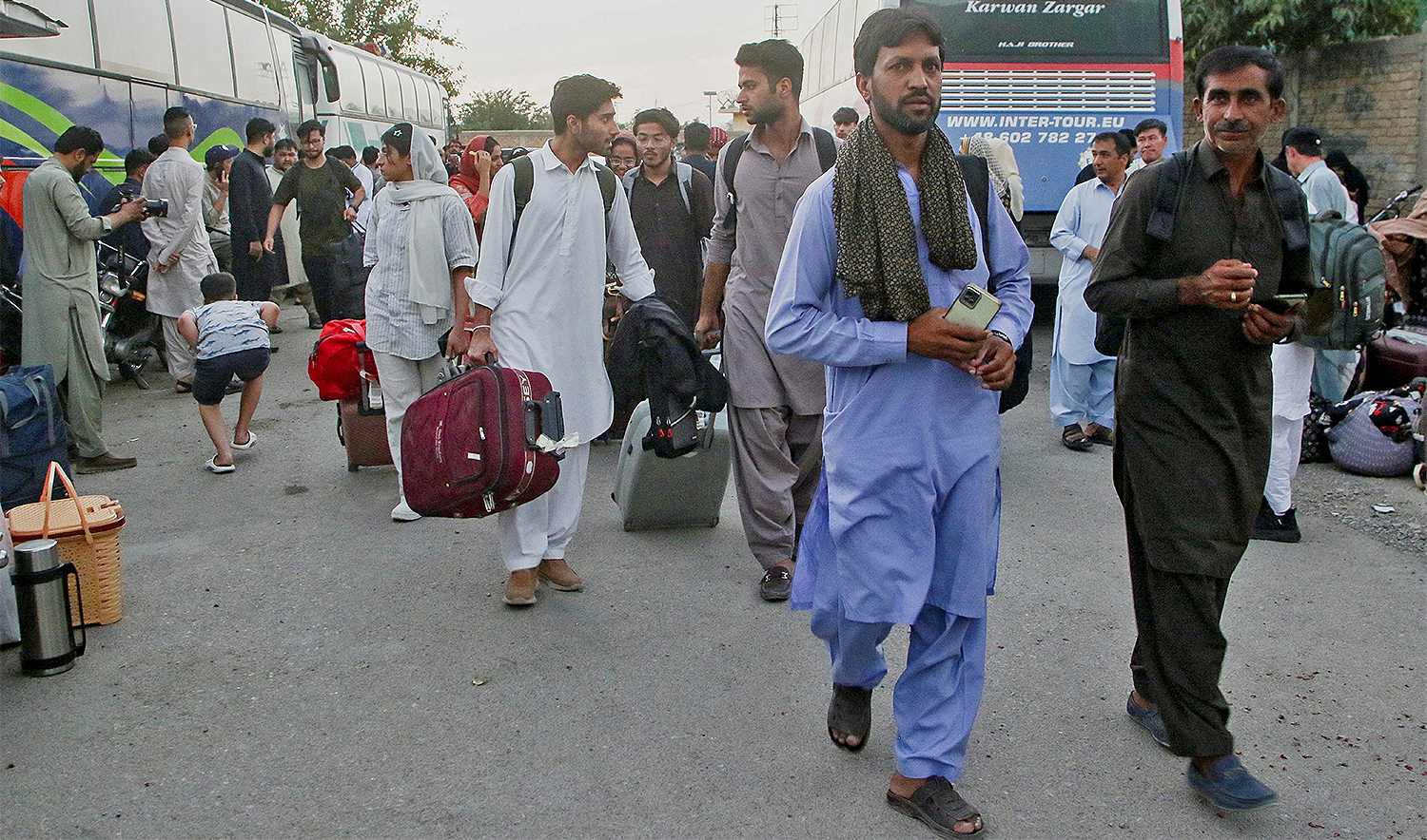 Pakistani students walk with their belongings after they returned from Iran, following the Israeli strikes in Iran, in Quetta, Pakistan on June 17, 2025. (REUTERS)