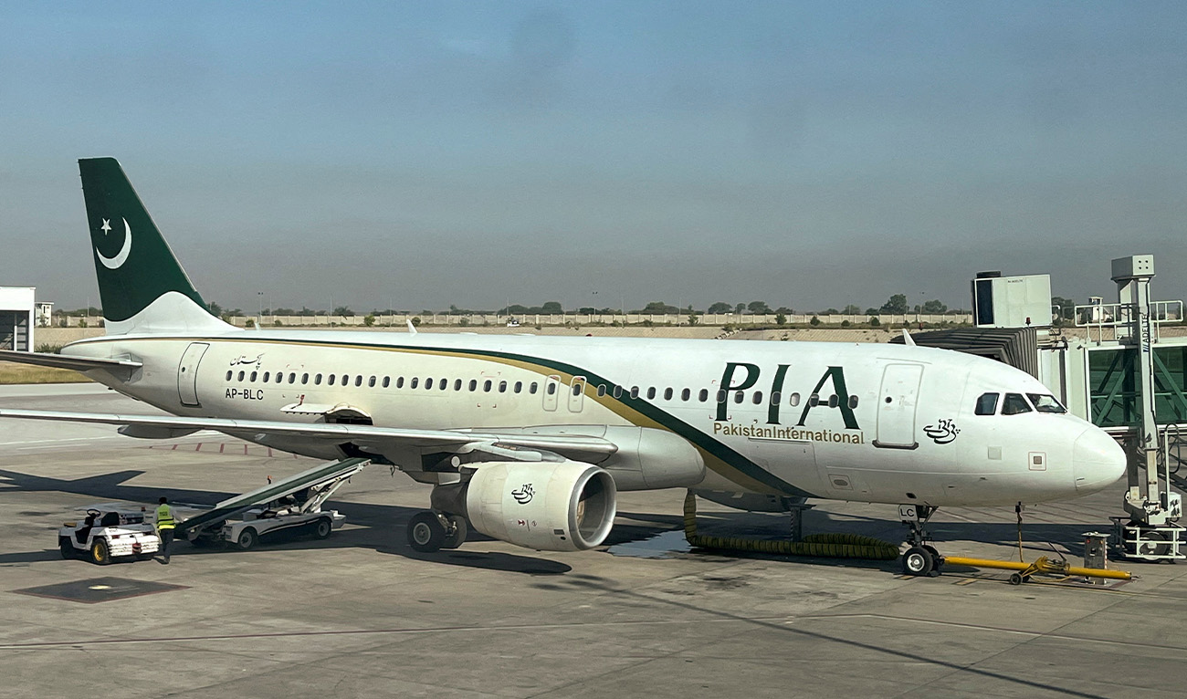 View of a Pakistan International Airlines (PIA) passenger plane, taken through a glass panel, at Islamabad International Airport, Pakistan on October 3, 2023. (Reuters/File)