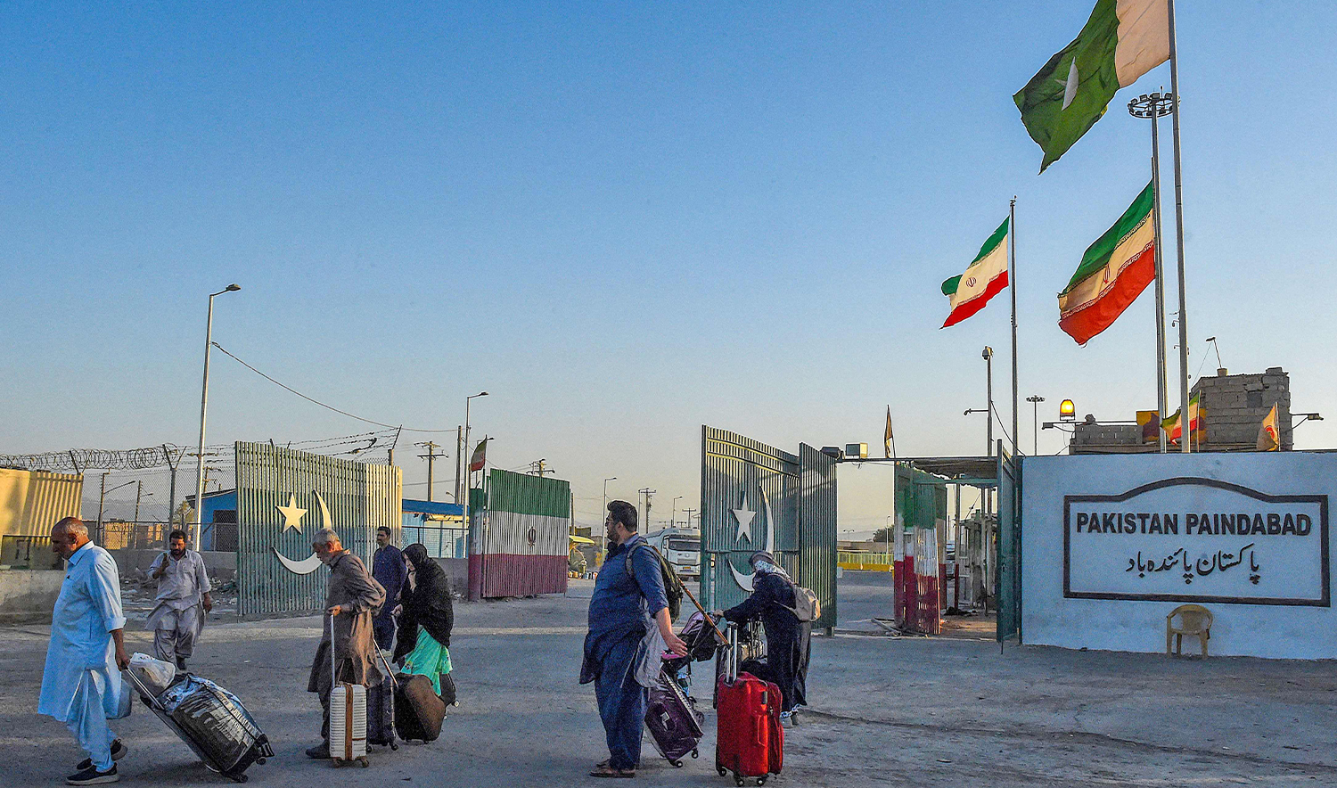 Pakistani pilgrims evacuated from Iran walk across the Pakistan-Iran border at Taftan, in Balochistan province on June 18, 2025, amid the ongoing conflict between Israel and Iran. (AFP)