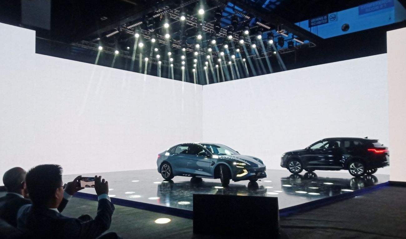 An attendee takes photos of the Chinese electric vehicle BYD models on display, during an event to announce the plans to open a car production plant in Pakistan, in Lahore, Pakistan August 17, 2024. (REUTERS)
