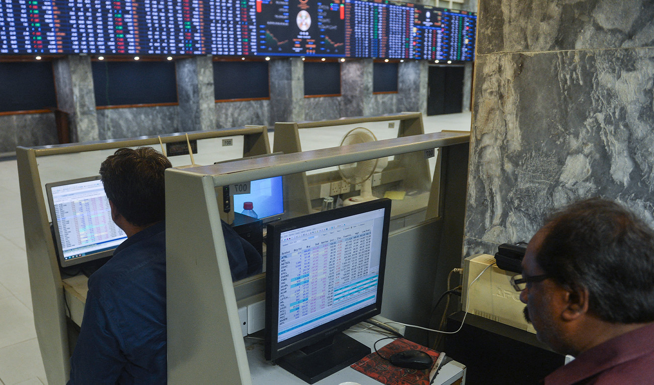 Brokers monitor the latests share prices at the Pakistan Stock Exchange in Karachi on February 14, 2023. (AFP/File)