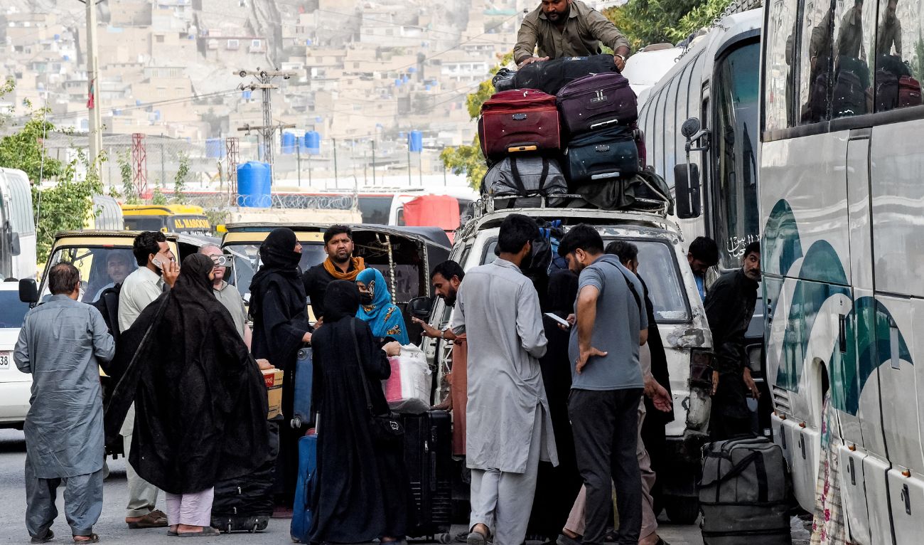 Pakistani nationals who were residing in Iran, arrive with their belongings in Quetta on June 22, 2025. (AFP)