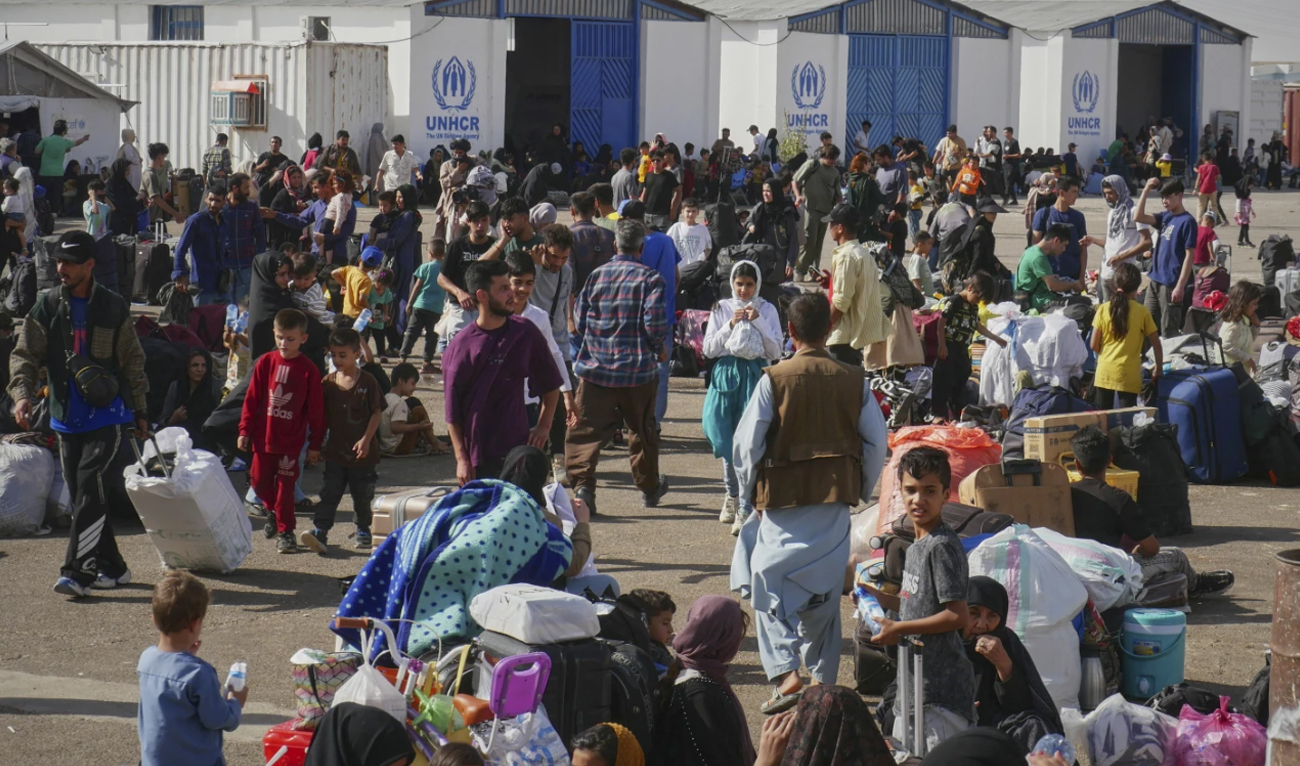 Afghan refugees who returned after fleeing Iran to escape deportation and conflict gather at a UNHCR facility near the Islam Qala crossing in western Herat province, Afghanistan on June 20, 2025. (AP)