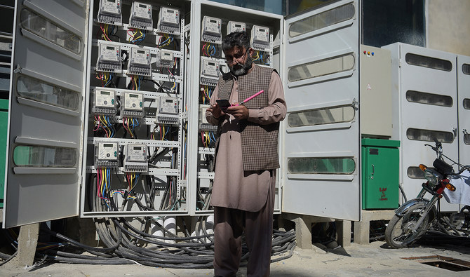 Muhammad Noshad, a Pakistani employee of the state-run Islamabad Electric Supply Company (IESCO), takes a meter reading with his smartphone at a commercial building in Islamabad on November 7, 2018. (AFP/File)