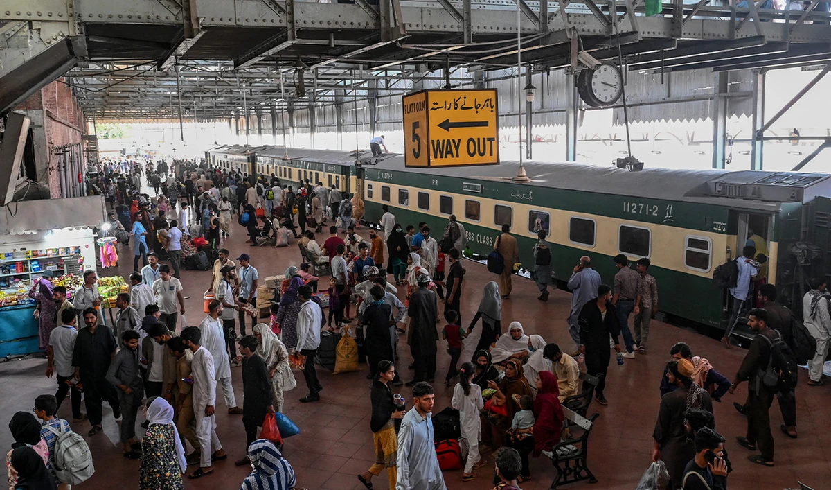 People wait to board a train at a railway station in Lahore on June 15, 2024, as they travel back home ahead of Eid al-Adha, the feast of the sacrifice marking the end of the Hajj pilgrimage to Mecca. (AFP/File)
