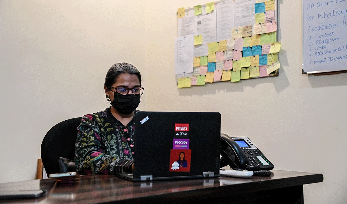 In this photograph taken on October 21, 2024, a staff member works at the Digital Rights Foundation (DRF), an NGO aims to strengthen protections for human rights defenders in digital spaces, in Lahore, Pakistan.